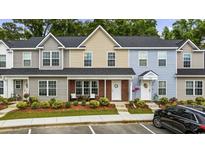 Charming townhomes with colorful siding, front porches, and well-maintained landscaping offer curb appeal at 2728 Mercer Dr. # 2728, Conway, SC 29526