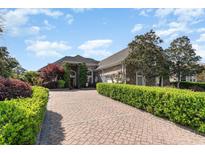 Beautiful brick home featuring a paver driveway and meticulously manicured landscaping at 276 Waterfall Circle, Little River, SC 29566