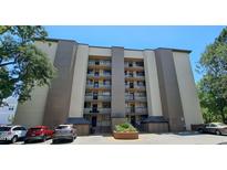Multi-story condo building with parking, lush trees, and well-kept grounds at 310 N 73Rd Ave. N # 5D, Myrtle Beach, SC 29572