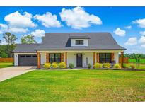Charming, single story home with a well-manicured lawn and beautiful landscaping at 3117 Chapel Rd., Loris, SC 29569
