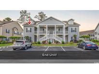 Charming two-story condo with a covered porch and well-maintained landscaping at 339 Black Oak Ln. # 201, Murrells Inlet, SC 29576