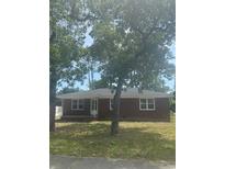 Charming single-story brick home featuring a well-manicured front yard and mature trees at 3816 Pine Lake Dr., Myrtle Beach, SC 29577