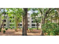 A three story condo building surrounded by lush foliage and trees at 415 Ocean Creek Dr. # 2145, Myrtle Beach, SC 29572
