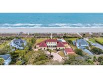 Stunning oceanfront estate with a red roof, private pool and lush landscaping at 4204 N Ocean Blvd., Myrtle Beach, SC 29577