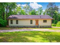 Charming single-story home with a welcoming orange front door and a well-maintained yard at 4391 Party Pines Rd., Conway, SC 29526