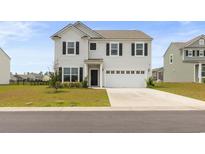 Charming two-story home featuring a two-car garage and well-maintained front yard with nice landscaping at 4425 Honir Dr., Myrtle Beach, SC 29579