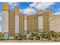 Beach Cove Resort featuring oceanfront views and a light neutral color scheme with blue accents on a sunny day at 4800 S Ocean Blvd. # 1402, North Myrtle Beach, SC 29582