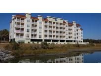 Spacious condo building with private balconies, parking garage, and beautiful pond view at 502 48Th Ave. S # 402, North Myrtle Beach, SC 29582