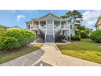 Charming two-story condo with inviting stairway and a well-maintained lawn at 5026 Belleglen Ct. # 101, Myrtle Beach, SC 29579