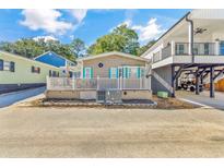 Charming home featuring a cozy front porch with white railing and blue shutters at 6001-1592 South Kings Hwy., Myrtle Beach, SC 29575