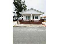 Charming home featuring a cozy front porch with brown wood trim at 6001-5117 S Kings Hwy., Myrtle Beach, SC 29575