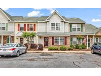 Charming townhome with colorful shutters, brick accents, and well-maintained landscaping at 604 Wilshire Ln. # 604, Murrells Inlet, SC 29576
