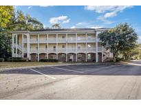 Inviting condo with a classic exterior, well-maintained landscaping, and convenient parking at 679 Riverwalk Dr. # 202, Myrtle Beach, SC 29579