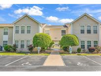 Inviting condo exterior with manicured landscaping, accessible parking, and pleasant curb appeal at 8570 Hopkins Circle # D, Surfside Beach, SC 29575