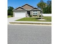 Charming one-story home featuring a well-maintained lawn and a white garage door at 112 Rialto Dr., Conway, SC 29526