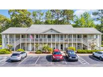 Inviting condo building with parking and lush landscaping, offering a serene living environment near the coast at 1260 White Tree Ln. # F, Myrtle Beach, SC 29588