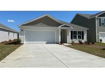Charming single-story home with a white facade, attached garage, and well-maintained landscaping at 152 Ashworth Dr., Tabor City, NC 28463