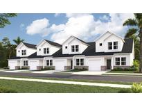 Charming new construction townhomes featuring white siding, brick accents, and attached garages, located in a desirable community at 2004 Wild Indigo Circle Nw # 111, Calabash, NC 28467
