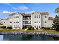 Beautiful condo complex with pond, landscaping, and balconies on a sunny day at 2262 Andover Dr. # E, Surfside Beach, SC 29575