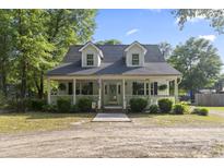 Charming home with a welcoming front porch and well-manicured landscaping at 228 Hopeland St., Pawleys Island, SC 29585