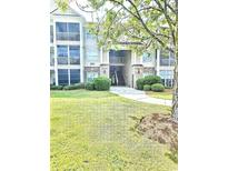 Attractive condo building exterior with brick accents, sidewalks, and professionally maintained landscaping at 290 Woodlands Way Nw # 10, Calabash, SC 28467