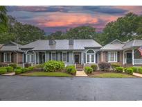 Charming townhome with well-manicured landscaping, a welcoming front porch, and an inviting curb appeal at 307 Golden Bear Dr. # 3, Pawleys Island, SC 29585