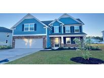 Charming two-story home with blue siding, stone accents, a two-car garage, and well-manicured lawn at 316 Glacier Way, Conway, SC 29526