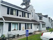 Exterior of property with gray siding, black shutters, and handicap parking spot at 500 Fairway Village Dr. # 6E, Myrtle Beach, SC 29588