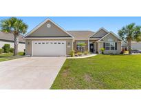 Charming home with a well-manicured lawn, palm trees, and a welcoming front entrance at 509 Fallen Leaf Ct., Myrtle Beach, SC 29588