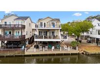 Charming waterfront home featuring multiple decks, offering stunning views and outdoor living spaces at 6001-308 South Kings Hwy., Myrtle Beach, SC 29575
