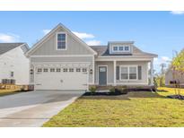 Charming single-Gathering home features a two-car garage, well-maintained lawn, and appealing architectural details at 605 Carter Reid Ct., Longs, SC 29568