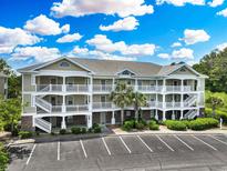Three-story condo building with ample parking and well-maintained landscaping at 6203 Catalina Dr. # 1832, North Myrtle Beach, SC 29582