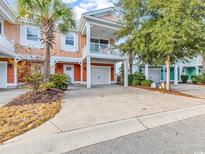 Charming beach home with orange facade, a front porch and a single car garage and landscaping at 820 Madiera Dr. # 14, North Myrtle Beach, SC 29582