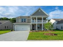 Charming two-story home with a gray exterior, landscaped lawn, and attached two-car garage at 867 Ireland Dr., Longs, SC 29568