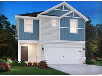 Charming two-story home boasts blue and gray siding, a two-car garage, and a welcoming front door and landscaped yard at 882 Cypress Preserve Circle, Longs, SC 29568
