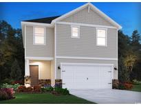 Two-story home showcasing a modern design, a two-car garage, and meticulous landscaping at 895 Cypress Preserve Circle, Longs, SC 29568
