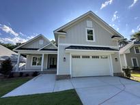 Charming exterior of a craftsman style home featuring a two-car garage and inviting front porch at 924 Morrall Dr., North Myrtle Beach, SC 29582