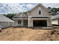 Charming single-Gathering home showcasing an attached garage, and a neutral color palette at 924 Morrall Dr., North Myrtle Beach, SC 29582