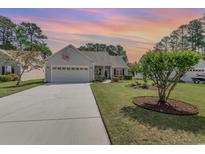 Charming single-story home featuring an attached two-car garage, mature landscaping, and inviting curb appeal at 1486 Medinah Ln., Murrells Inlet, SC 29576