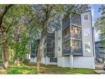 Condominium building with screened in porches, grassy lawn and mature trees at 1500 Cenith Dr. # F103, North Myrtle Beach, SC 29582