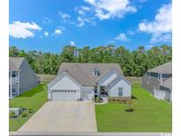 Beautiful home with a two-car garage and manicured front lawn, offering an inviting curb appeal at 1546 Villena Dr., Myrtle Beach, SC 29579