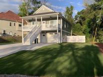 Charming two-story home with a double porch, white picket fence, and well-manicured lawn at 223 S 9Th Ave. S, North Myrtle Beach, SC 29582