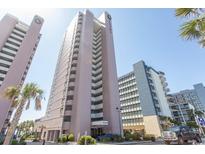 Low angle of condo building with palm trees and blue sky at 2406 N Ocean Blvd. # 803, Myrtle Beach, SC 29577