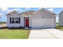 Charming single-Gathering home featuring a red front door, light gray siding, well-manicured lawn, and a two-car garage at 304 Clear Lake Dr., Conway, SC 29526