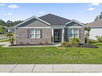 Charming single-story home with manicured lawn, brick facade, and dark shutters at 3056 Skylar Dr., Myrtle Beach, SC 29577
