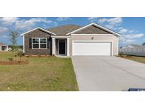 Charming single-story home featuring a two-car garage, manicured lawn, and classic design at 312 Clear Lake Dr., Conway, SC 29526