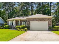 Charming brick home with well-manicured lawn and two-car garage in a desirable neighborhood at 3157 Hermitage Dr., Little River, SC 29566