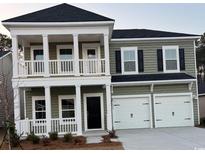 Charming two-story home with a welcoming front porch and two-car garage at 352 Magnolia Terrace Dr, Myrtle Beach, SC 29579