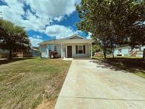 Charming single-story home featuring a well-manicured lawn and a concrete driveway under a bright blue sky at 3863 Stern Dr., Conway, SC 29526
