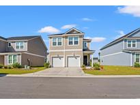 Charming two-story home featuring a two car garage and beautifully maintained front yard at 3968 Hibiscus Dr., Little River, SC 29566
